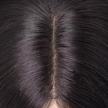 Premium monofilament base hair topper close-up showing hand-tied hair mimicking real scalp