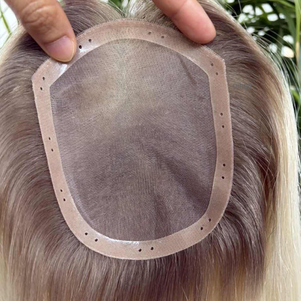 Close-up of threading natural hair through PU perimeter holes on a 4x5 hair topper without clips.