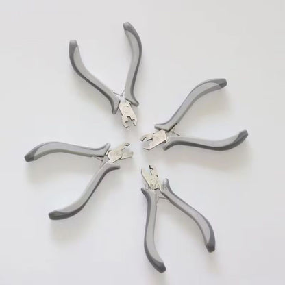 Ergonomic grey and white handles of hair extension pliers.